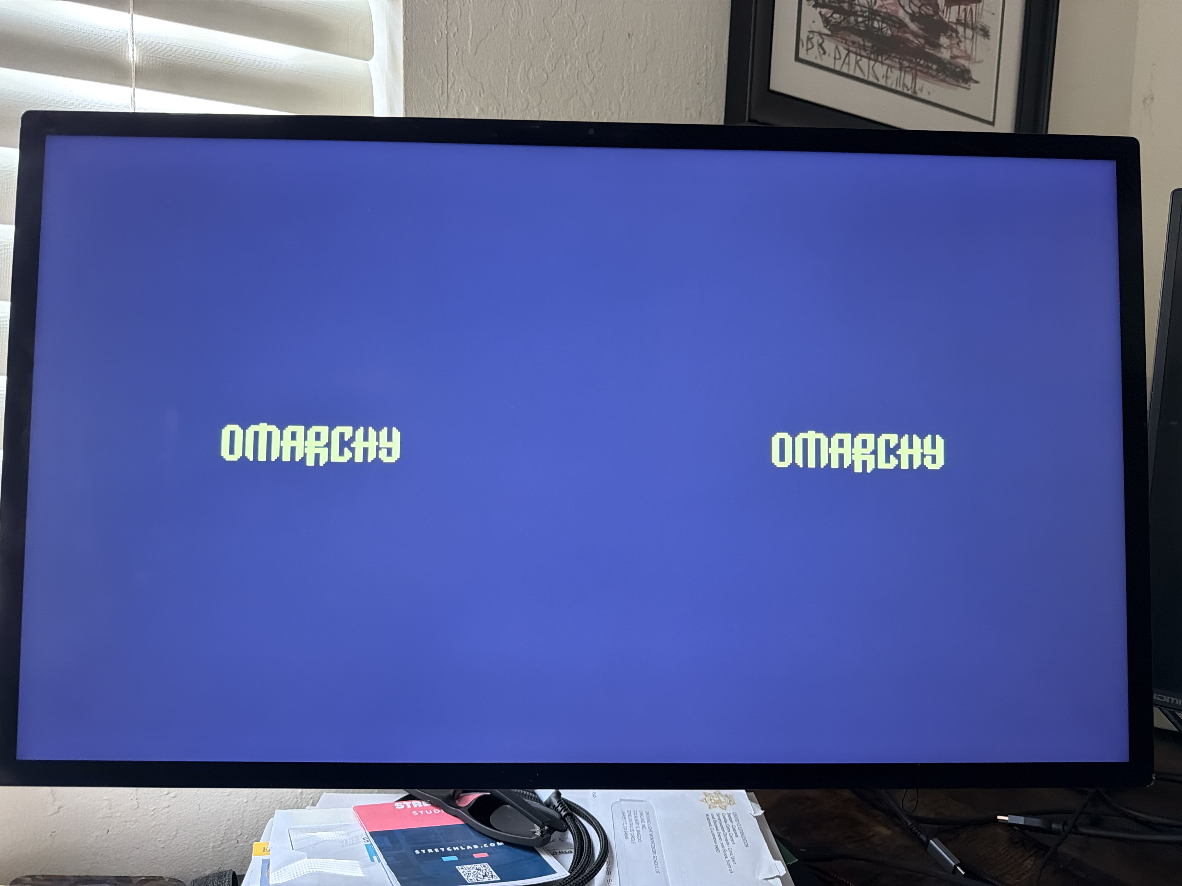 The Omarchy boot screen stalled on the external monitor, the logo frozen instead of progressing